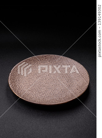 An empty ceramic round plate, kitchen utensils for a dinner table. An empty plate An empty ceramic round plate, kitchen utensils for a dinner table. An empty plate 139149302