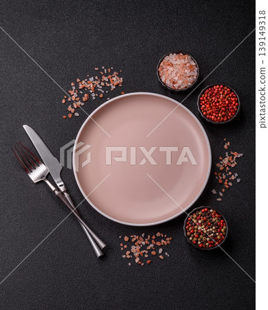 An empty ceramic round plate, kitchen utensils for a dinner table. An empty plate An empty ceramic round plate, kitchen utensils for a dinner table. An empty plate 139149318