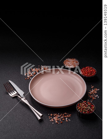 An empty ceramic round plate, kitchen utensils for a dinner table. An empty plate An empty ceramic round plate, kitchen utensils for a dinner table. An empty plate 139149319