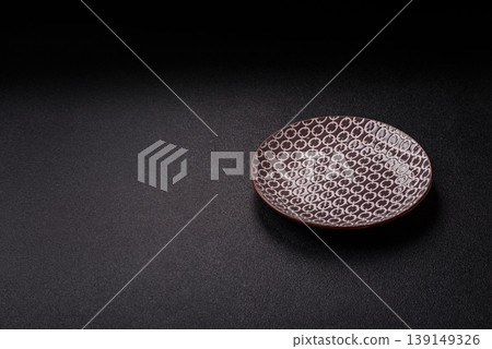 An empty ceramic round plate, kitchen utensils for a dinner table. An empty plate An empty ceramic round plate, kitchen utensils for a dinner table. An empty plate 139149326