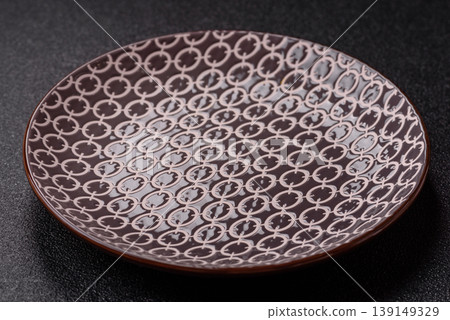 An empty ceramic round plate, kitchen utensils for a dinner table. An empty plate An empty ceramic round plate, kitchen utensils for a dinner table. An empty plate 139149329
