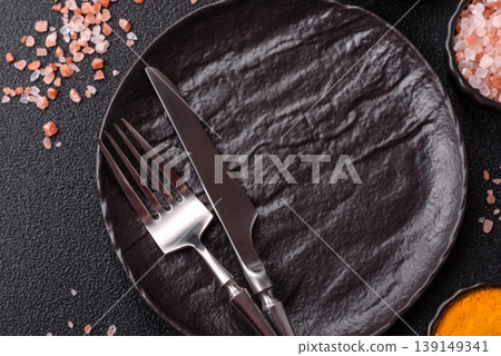 An empty ceramic round plate, kitchen utensils for a dinner table. An empty plate An empty ceramic round plate, kitchen utensils for a dinner table. An empty plate 139149341