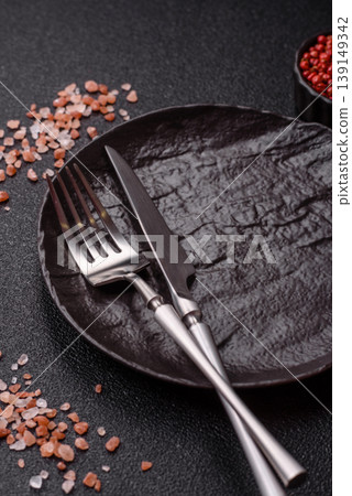 An empty ceramic round plate, kitchen utensils for a dinner table. An empty plate 139149342