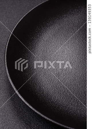 An empty ceramic round plate, kitchen utensils for a dinner table. An empty plate An empty ceramic round plate, kitchen utensils for a dinner table. An empty plate 139149353