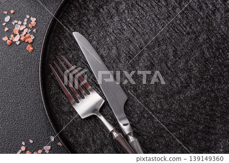 An empty ceramic round plate, kitchen utensils for a dinner table. An empty plate An empty ceramic round plate, kitchen utensils for a dinner table. An empty plate 139149360