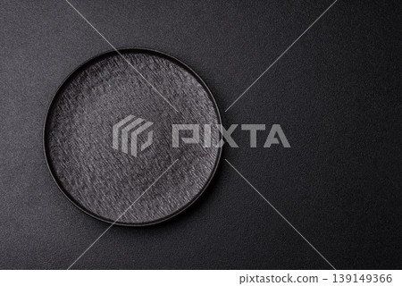 An empty ceramic round plate, kitchen utensils for a dinner table. An empty plate An empty ceramic round plate, kitchen utensils for a dinner table. An empty plate 139149366