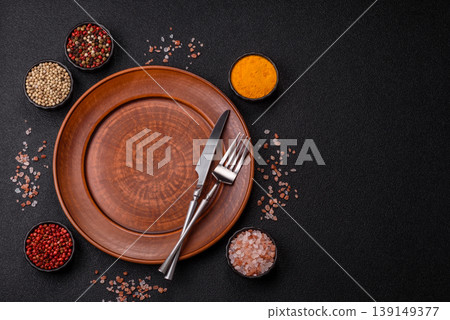 An empty ceramic round plate, kitchen utensils for a dinner table. An empty plate An empty ceramic round plate, kitchen utensils for a dinner table. An empty plate 139149377
