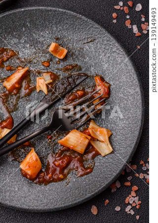 A dirty plate after a meal with leftover pasta and tomato sauce, cleaning. An empty dirty plate A dirty plate after a meal with leftover pasta and tomato sauce, cleaning. An empty dirty plate 139149493