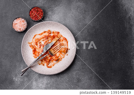 A dirty plate after a meal with leftover pasta and tomato sauce, cleaning. An empty dirty plate A dirty plate after a meal with leftover pasta and tomato sauce, cleaning. An empty dirty plate 139149519
