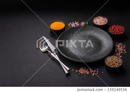 An empty ceramic round plate, kitchen utensils for a dinner table. An empty plate An empty ceramic round plate, kitchen utensils for a dinner table. An empty plate 139149556