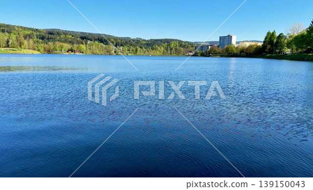 Captivating video of a serene lake, lush trees, and mountains Captivating video of a serene lake, lush trees, and mountains 139150043