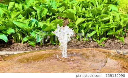 A serene garden with a fountain, lush plants, and tranquil pond A serene garden with a fountain, lush plants, and tranquil pond 139150090