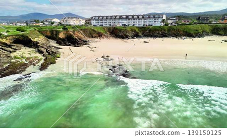Experience the breathtaking beauty of a serene coastal beach with clear waters for relaxation 139150125