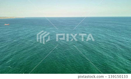Captivating Aerial View of the Clear Blue Ocean Waters with Various Cargo Ships Dotted Across Captivating Aerial View of the Clear Blue Ocean Waters with Various Cargo Ships Dotted Across 139150133