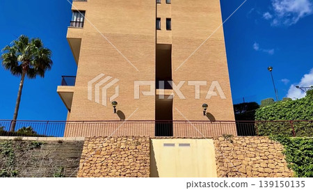 A Truly Stunning and Modern Architectural Marvel Standing Tall Against a Bright Blue Sky Above A Truly Stunning and Modern Architectural Marvel Standing Tall Against a Bright Blue Sky Above 139150135