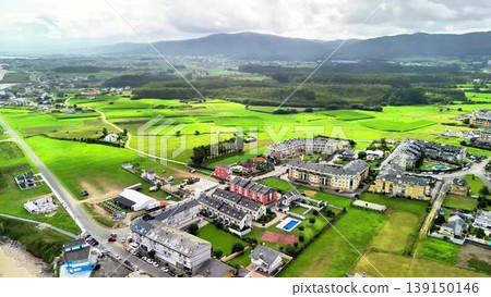 A breathtaking aerial view showcasing the lush green landscapes alongside modern urban development A breathtaking aerial view showcasing the lush green landscapes alongside modern urban development 139150146