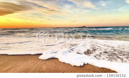 Experience the Serene Sunset Waves on the Sandy Beach, a perfect paradise destination Experience the Serene Sunset Waves on the Sandy Beach, a perfect paradise destination 139150152