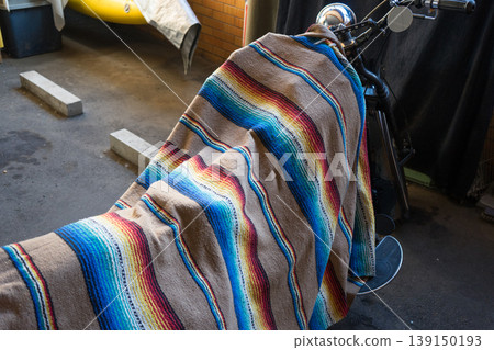 Cloth covering a stored motorcycle Cloth covering a stored motorcycle 139150193