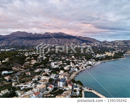 Serene coastal sunset, Tranquil seaside view at dusk, Calm ocean horizon with peaceful seaside scene 139150242