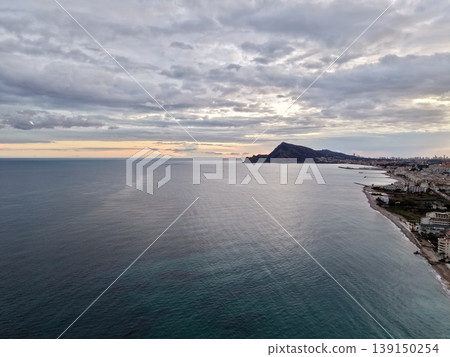 Tranquil seaside with glowing sunset, Peaceful coastal scene featuring soft ripples and warm sunset rays Tranquil seaside with glowing sunset, Peaceful coastal scene featuring soft ripples and warm sunset rays 139150254