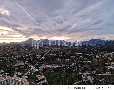 Stormy evening landscape, Dark clouds hover over countryside, Gloomy sky looms above rolling hills scene 139150262