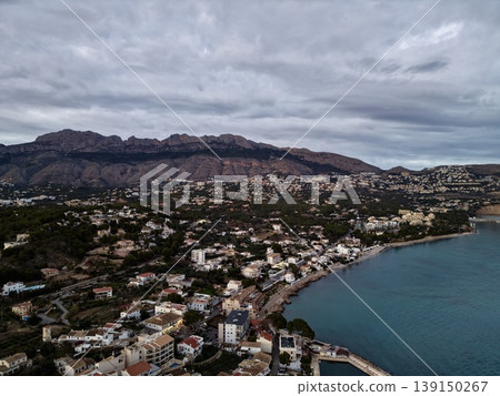 Gloomy seaside landscape, Coastal area under heavy clouds with stormy atmosphere and textured rooftops Gloomy seaside landscape, Coastal area under heavy clouds with stormy atmosphere and textured rooftops 139150267