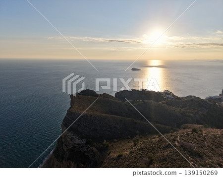 High precipice over aqua sea landscape, Jagged cliff overlooking vibrant blue waters and rugged terrain High precipice over aqua sea landscape, Jagged cliff overlooking vibrant blue waters and rugged terrain 139150269