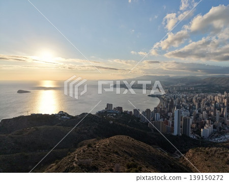 Vibrant evening setting showcases highrise buildings with shimmering water reflections and vivid sky 139150272