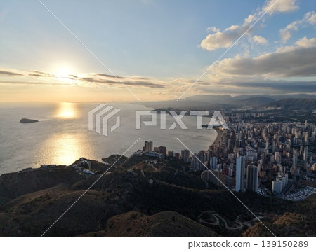 Beautiful twilight illuminating harbor cityscape with shimmering reflections and glowing structures Beautiful twilight illuminating harbor cityscape with shimmering reflections and glowing structures 139150289