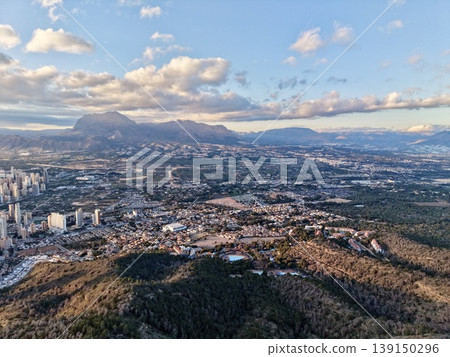 Urban growth landscape, City expansion with mountain view, Sprawling cityscape against mountain and bay 139150296