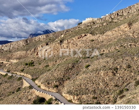 Sunny route through rocky landscape, Glowing hiking trail weaving through arid land and craggy formations Sunny route through rocky landscape, Glowing hiking trail weaving through arid land and craggy formations 139150330