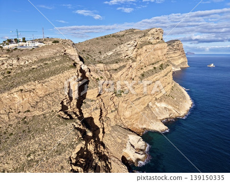 Breathtaking aerial vantage showcasing precipitous coastlines and turbulent ocean currents in vibrant colors Breathtaking aerial vantage showcasing precipitous coastlines and turbulent ocean currents in vibrant colors 139150335