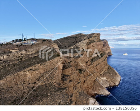 Cliff view showcase, Breathtaking perspective of cliff face highlighting geological features and vegetation 139150356