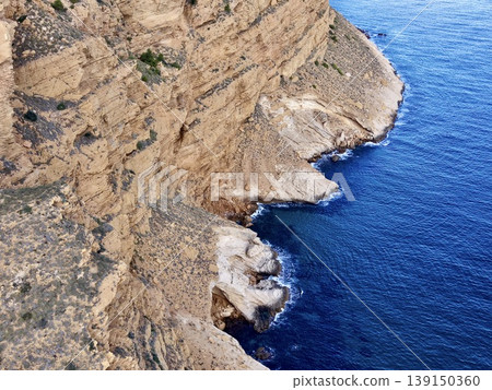 Detailed aerial view of coastal formations, High contrast imagery of shoreline features and sea caves Detailed aerial view of coastal formations, High contrast imagery of shoreline features and sea caves 139150360