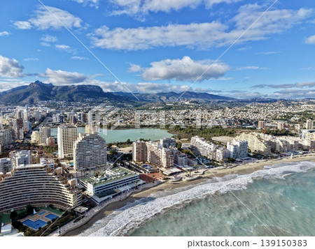 Mountains overlook peaceful ocean scenes, Relaxing coastal view with distant peaks and peaceful waters 139150383