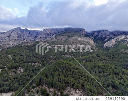 Scenic mountain and forest scene, Vast rugged mountain scenery with atmospheric lighting and shadows 139150390