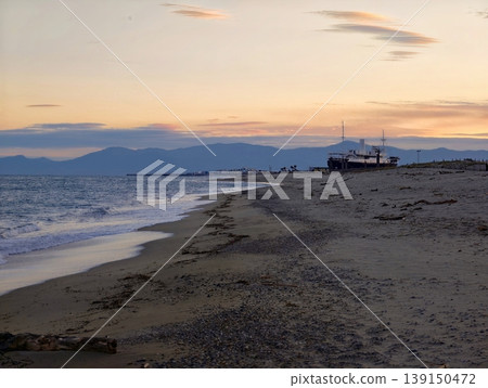 Peaceful harbor at sunset. Calm seaside dock scene featuring moored vessel and soft sky colors Peaceful harbor at sunset. Calm seaside dock scene featuring moored vessel and soft sky colors 139150472