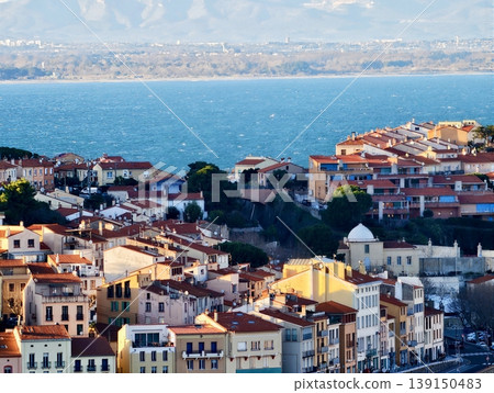 Seaside hillside scenery. Elevated area overlooking ocean with colorful roofs and narrow streets 139150483