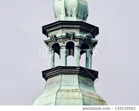 Textured copper dome with classical columns and weathered artistic appearance against light sky Textured copper dome with classical columns and weathered artistic appearance against light sky 139150502
