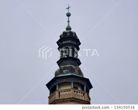 Old sandstone tower with copper cap. Traditional sandstone edifice featuring copper top and green patina Old sandstone tower with copper cap. Traditional sandstone edifice featuring copper top and green patina 139150516