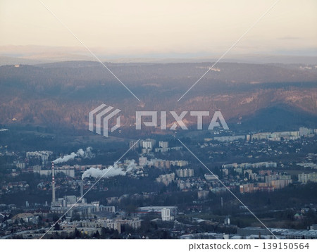 Chilly cityscape view. Winter landscape depicting industrial and communal textures of hillside urban area Chilly cityscape view. Winter landscape depicting industrial and communal textures of hillside urban area 139150564