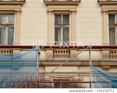 Carefully restoring and safeguarding historic facade of ancient structure with protective measures Carefully restoring and safeguarding historic facade of ancient structure with protective measures 139150771