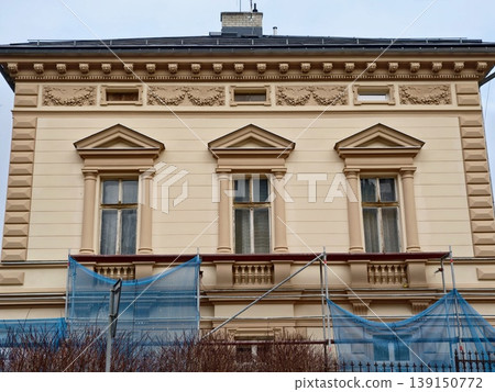 Renovation with safety measures. Preservation efforts involving scaffolding and safety barriers Renovation with safety measures. Preservation efforts involving scaffolding and safety barriers 139150772
