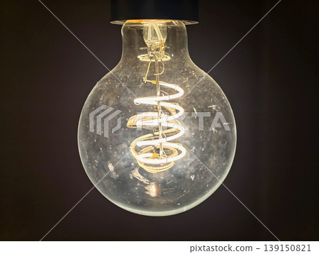 Classic incandescent bulb with visible filament represents innovation and creative thinking Classic incandescent bulb with visible filament represents innovation and creative thinking 139150821