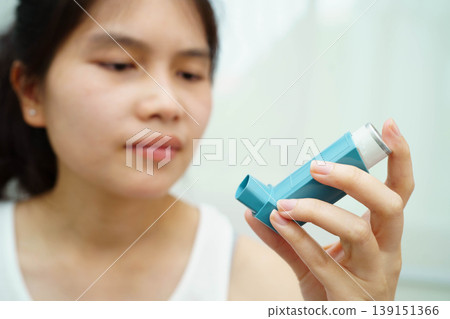 Asthma and chronic obstructive pulmonary disease COPD, Asian teenage using metered dose inhaler MDI. Asthma and chronic obstructive pulmonary disease COPD, Asian teenage using metered dose inhaler MDI. 139151366