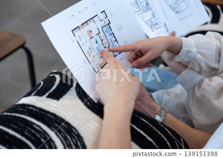 The hands of a couple discussing house plans. The hands of a couple discussing house plans. 139151398