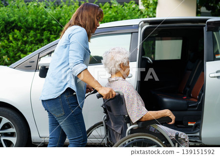 Caregiver help Asian elderly woman disability patient use wheelchair to get in car. Caregiver help Asian elderly woman disability patient use wheelchair to get in car. 139151592