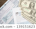 Tax form 1040 U.S. Individual Income Tax Return with dollar banknotes money. 139151623