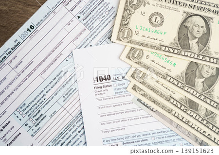 Tax form 1040 U.S. Individual Income Tax Return with dollar banknotes money. 139151623