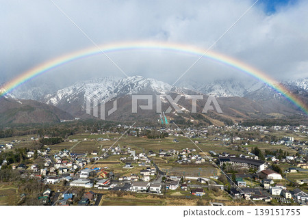 A beautiful rainbow over Hakuba Village and the snow-capped Happo-one ridge, Nagano Prefecture (aerial photograph taken by drone). A beautiful rainbow over Hakuba Village and the snow-capped Happo-one ridge, Nagano Prefecture (aerial photograph taken by drone). 139151755